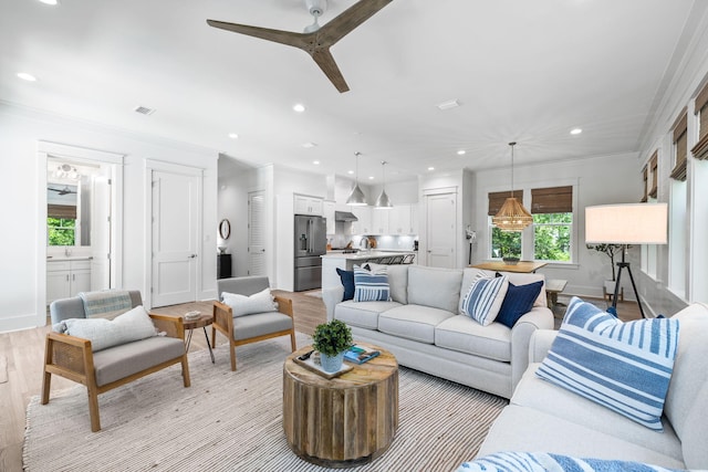 213 Spotted Dolphin Rd, Santa Rosa Beach, FL 32459 - living room featuring a ceiling fan, recessed lighting, crown molding, and light wood-style floors
