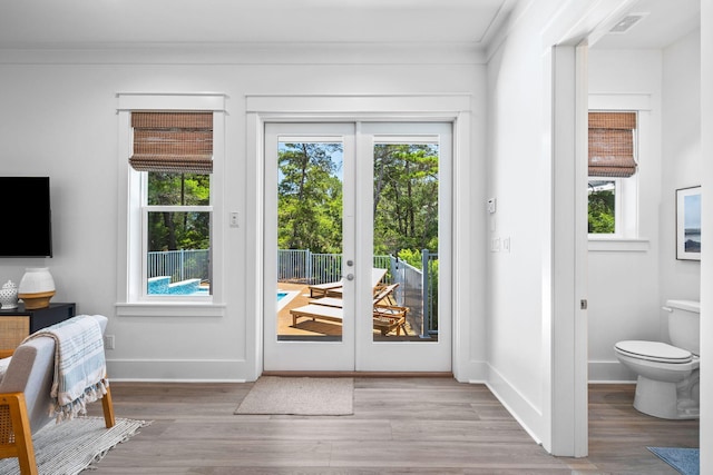 213 Spotted Dolphin Rd, Santa Rosa Beach, FL 32459 - entryway with healthy amount of natural light, french doors, wood finished floors, and crown molding