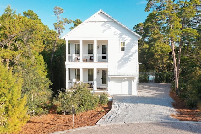 213 Spotted Dolphin Rd, Santa Rosa Beach, FL 32459 - greek revival inspired property featuring a balcony, a porch, gravel driveway, and an attached garage