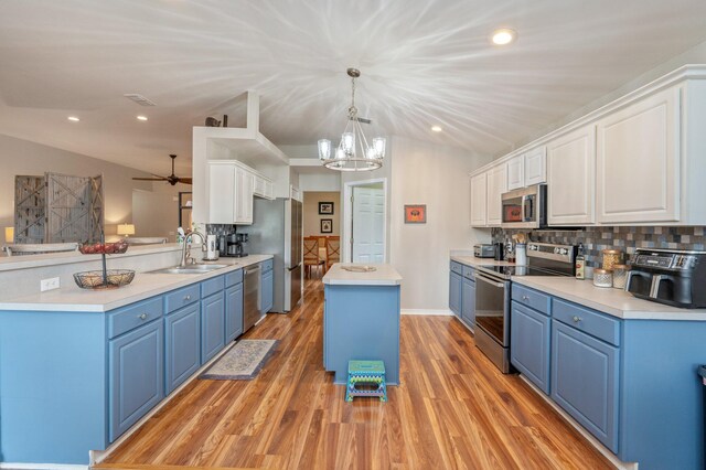 337 Peggy Dr, Crestview, FL 32536 - kitchen with stainless steel appliances, blue cabinetry, a center island, light wood finished floors, and recessed lighting