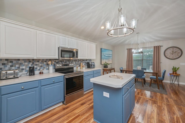 337 Peggy Dr, Crestview, FL 32536 - kitchen with blue cabinets, appliances with stainless steel finishes, a chandelier, white cabinetry, and light wood-style floors