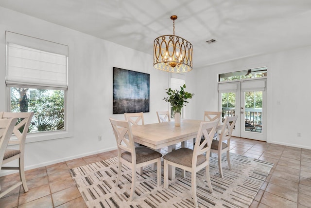 69 Lake Pointe Dr, Santa Rosa Beach, FL 32459 - dining space with french doors, light tile patterned flooring, and a chandelier