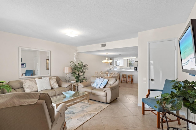 3705 E Old Highway 98 # 6, Destin, FL 32541 - living area featuring a chandelier, light tile patterned floors, and a textured ceiling