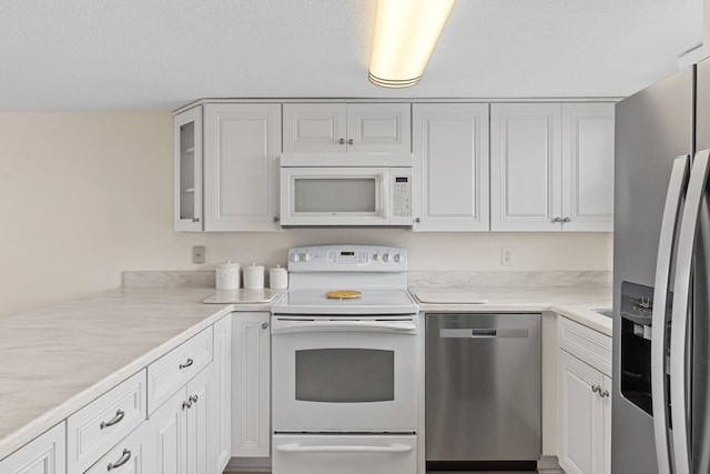 3705 E Old Highway 98 # 6, Destin, FL 32541 - kitchen with appliances with stainless steel finishes, white cabinetry, light countertops, and glass insert cabinets