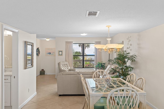 3705 E Old Highway 98 # 6, Destin, FL 32541 - dining room featuring light tile patterned flooring, a chandelier, and a textured ceiling