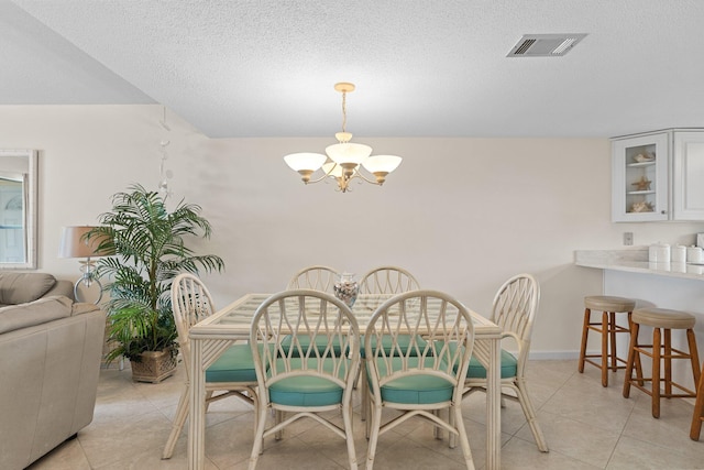 3705 E Old Highway 98 # 6, Destin, FL 32541 - dining room with a chandelier, light tile patterned floors, and a textured ceiling