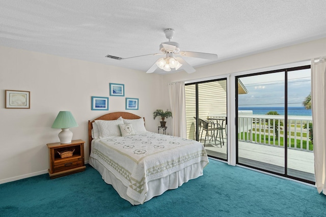 3705 E Old Highway 98 # 6, Destin, FL 32541 - bedroom with access to exterior, carpet, multiple windows, and a textured ceiling