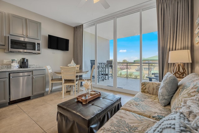 1517 SW Miracle Strip Pkwy Unit 309, Fort Walton Beach, FL 32548 - living room featuring light tile patterned floors, ceiling fan, and a wall of windows