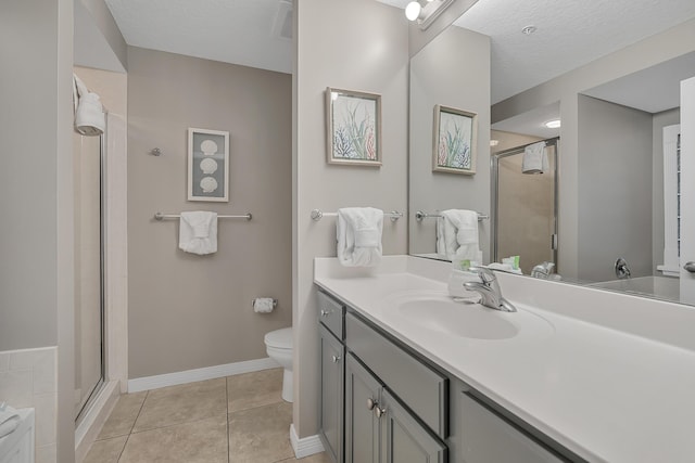 1517 SW Miracle Strip Pkwy Unit 309, Fort Walton Beach, FL 32548 - bathroom featuring vanity, a shower stall, tile patterned flooring, and a textured ceiling