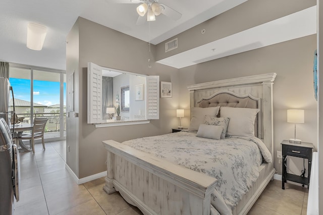1517 SW Miracle Strip Pkwy Unit 309, Fort Walton Beach, FL 32548 - bedroom featuring access to outside, light tile patterned floors, and freestanding refrigerator