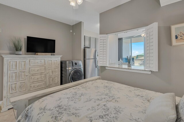 1517 SW Miracle Strip Pkwy Unit 309, Fort Walton Beach, FL 32548 - tiled bedroom with freestanding refrigerator and washer / clothes dryer