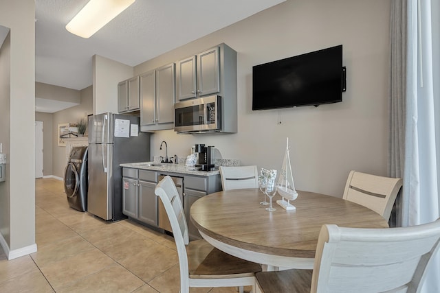1517 SW Miracle Strip Pkwy Unit 309, Fort Walton Beach, FL 32548 - dining room featuring washer / dryer and light tile patterned floors
