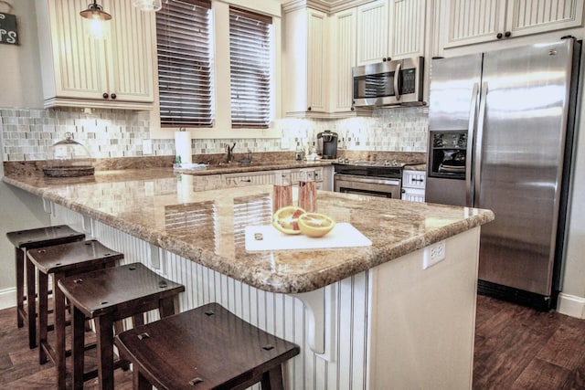 192 E Blue Crab Loop, Inlet Beach, FL 32461 - kitchen featuring stainless steel appliances, dark wood finished floors, light stone countertops, and decorative backsplash