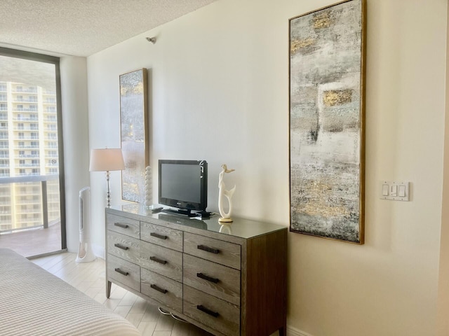 1096 Scenic Gulf Dr Unit 1512, Miramar Beach, FL 32550 - bedroom with floor to ceiling windows and a textured ceiling