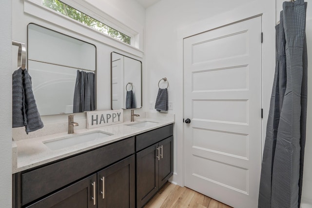 2940 Mccarty Ave, Crestview, FL 32539 - full bathroom featuring double vanity, wood finished floors, and a shower with curtain