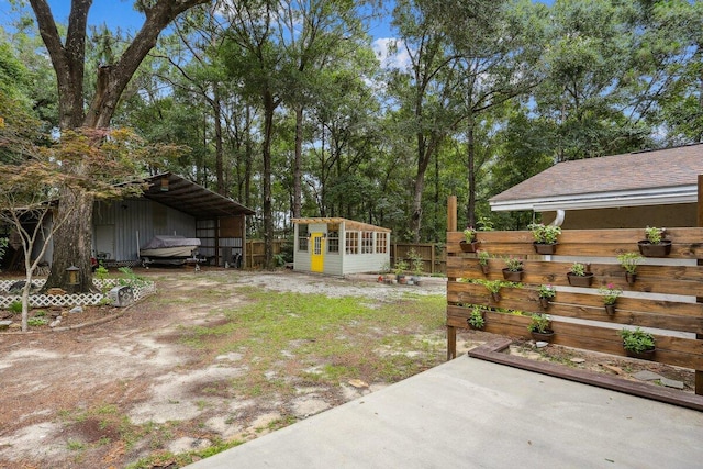 107 Shell Dr, Crestview, FL 32536 - view of yard featuring an outbuilding and a detached carport