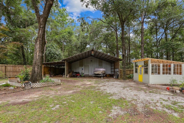 107 Shell Dr, Crestview, FL 32536 - view of yard featuring a detached carport, an outbuilding, and driveway
