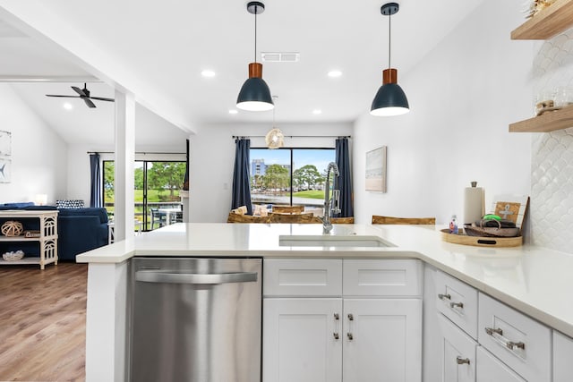 431 Linkside Cir, Miramar Beach, FL 32550 - kitchen featuring stainless steel dishwasher, open shelves, open floor plan, light countertops, and a peninsula
