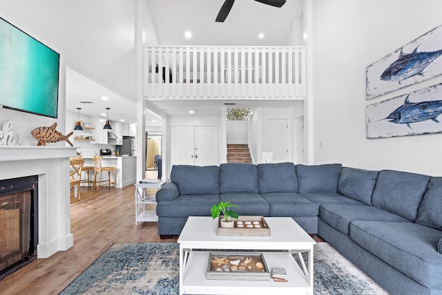 431 Linkside Cir, Miramar Beach, FL 32550 - living area with a high ceiling, ceiling fan, a fireplace, wood finished floors, and recessed lighting