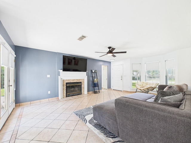 422 John King Rd, Crestview, FL 32539 - living area with light tile patterned floors, a ceiling fan, and a fireplace