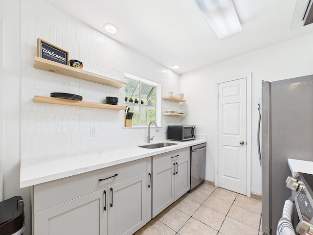 422 John King Rd, Crestview, FL 32539 - kitchen with stainless steel appliances, open shelves, light tile patterned floors, light stone counters, and backsplash