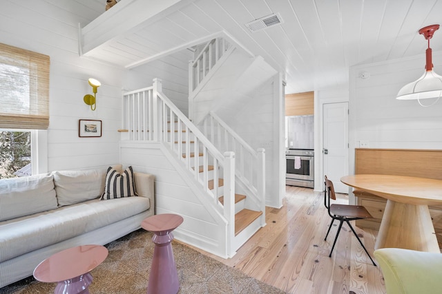 54 Roberts Way, Santa Rosa Beach, FL 32459 - living room featuring light wood-style floors, wood walls, stairway, and wooden ceiling