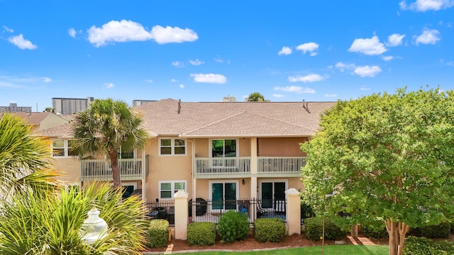 134 Damon Cir Unit Q, Panama City Beach, FL 32407 - rear view of house featuring stucco siding, a balcony, and a shingled roof