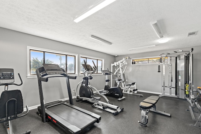 134 Damon Cir Unit Q, Panama City Beach, FL 32407 - exercise room featuring a textured ceiling and baseboards