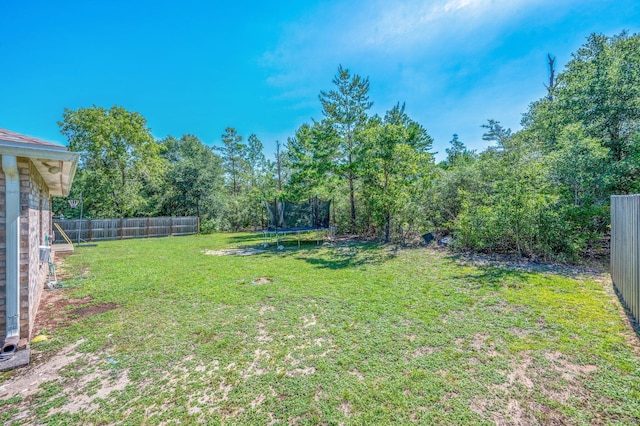 80 Azalea Trce, Defuniak Springs, FL 32433 - fenced backyard featuring a trampoline