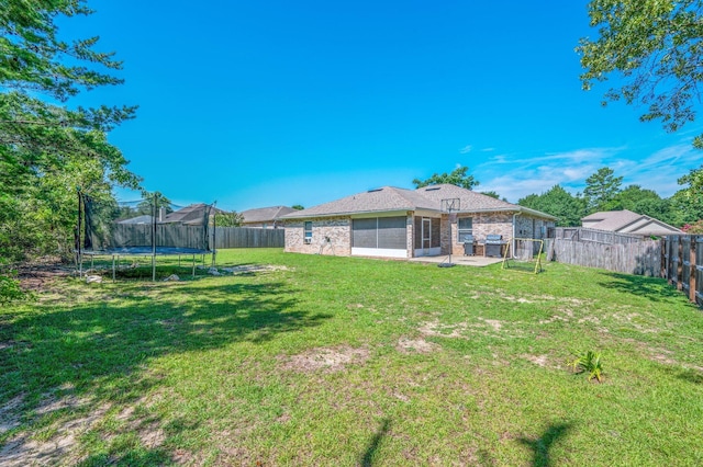 80 Azalea Trce, Defuniak Springs, FL 32433 - fenced backyard featuring a trampoline and a patio