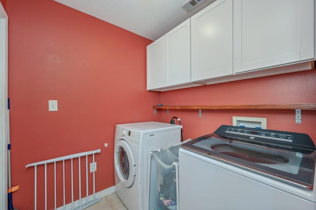 80 Azalea Trce, Defuniak Springs, FL 32433 - washroom featuring cabinet space, washing machine and clothes dryer, and light tile patterned floors