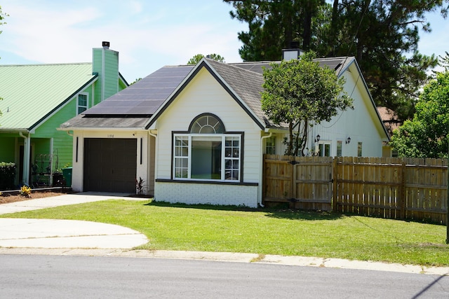 1198 Saddle Creek Dr, Fort Walton Beach, FL 32547 - view of front of home with a garage, a chimney, driveway, roof mounted solar panels, and brick siding