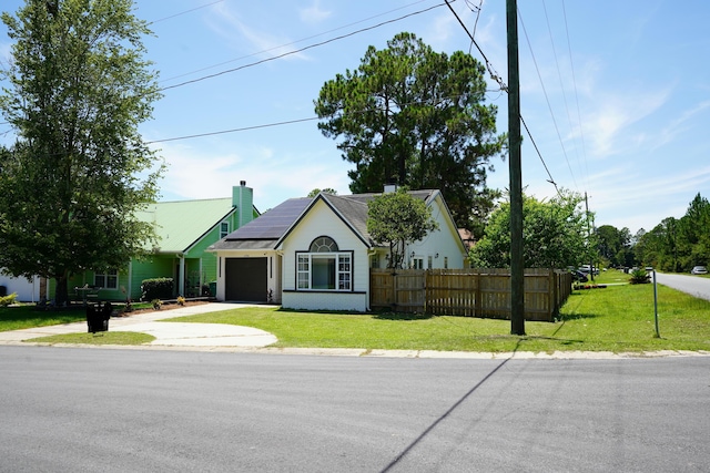 1198 Saddle Creek Dr, Fort Walton Beach, FL 32547 - ranch-style house with a garage, roof mounted solar panels, driveway, and a chimney