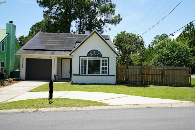 1198 Saddle Creek Dr, Fort Walton Beach, FL 32547 - view of front of home featuring concrete driveway, a garage, solar panels, brick siding, and a shingled roof