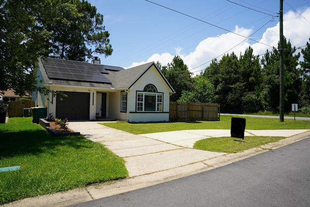 1198 Saddle Creek Dr, Fort Walton Beach, FL 32547 - view of front of property featuring driveway, roof mounted solar panels, a garage, a chimney, and roof with shingles