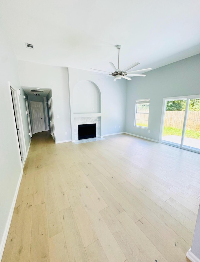 1198 Saddle Creek Dr, Fort Walton Beach, FL 32547 - unfurnished living room with light wood-style flooring, a ceiling fan, and a fireplace