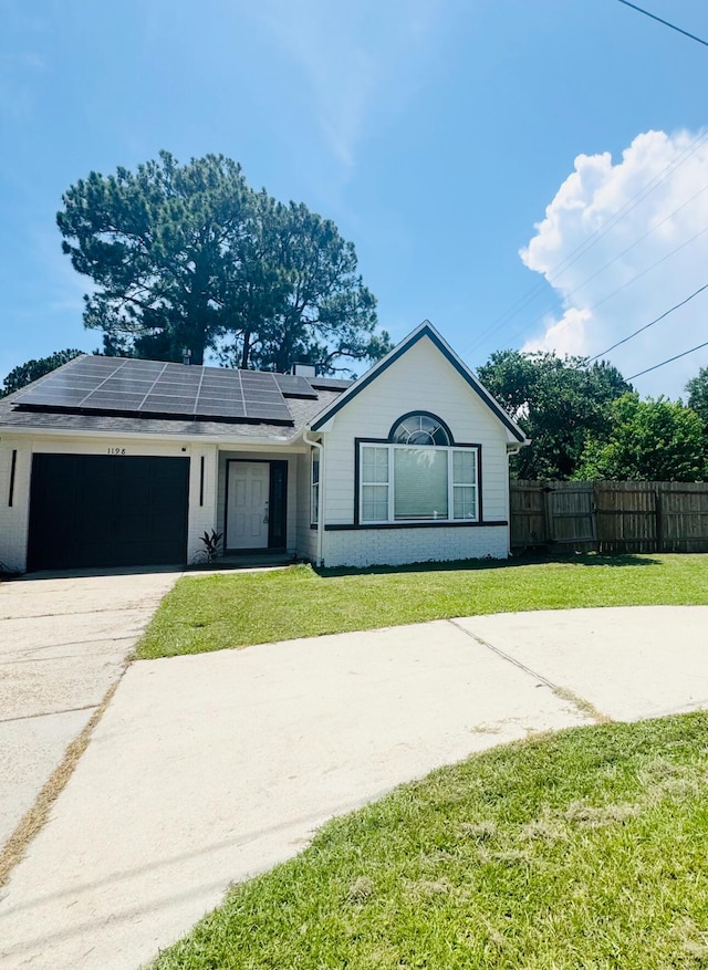 1198 Saddle Creek Dr, Fort Walton Beach, FL 32547 - ranch-style home with driveway, roof mounted solar panels, and an attached garage
