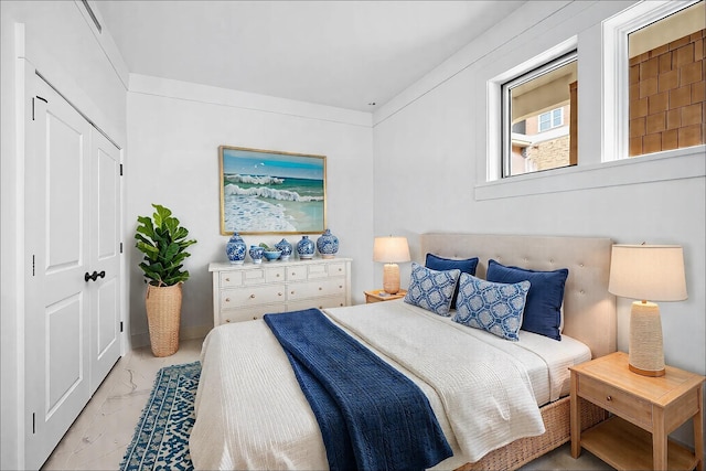 1101 Sawgrass Ct Unit 102, Panama City Beach, FL 32413 - bedroom with light marble finish flooring and a closet