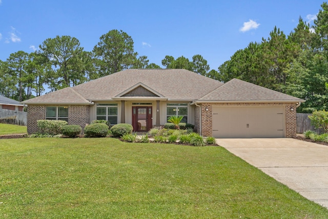 7478 Brevard St, Navarre, FL 32566 - view of front of property with a garage, driveway, brick siding, and roof with shingles
