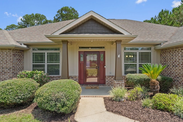 7478 Brevard St, Navarre, FL 32566 - property entrance featuring brick siding and roof with shingles