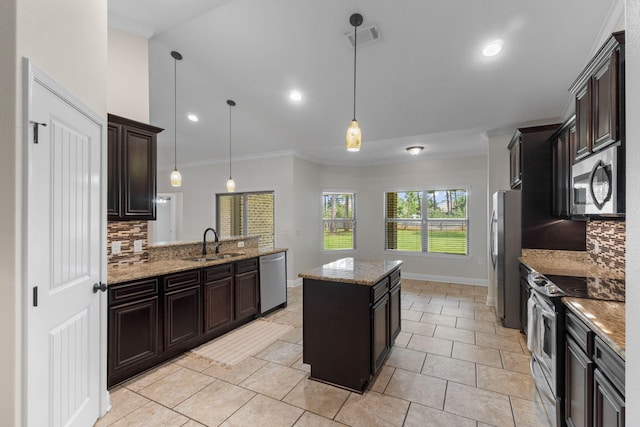 7478 Brevard St, Navarre, FL 32566 - kitchen with appliances with stainless steel finishes, backsplash, a kitchen island, crown molding, and pendant lighting