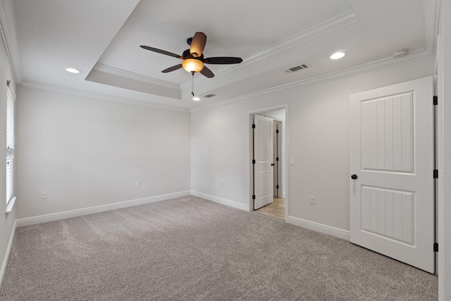 7478 Brevard St, Navarre, FL 32566 - empty room featuring ornamental molding, a ceiling fan, a raised ceiling, recessed lighting, and light colored carpet