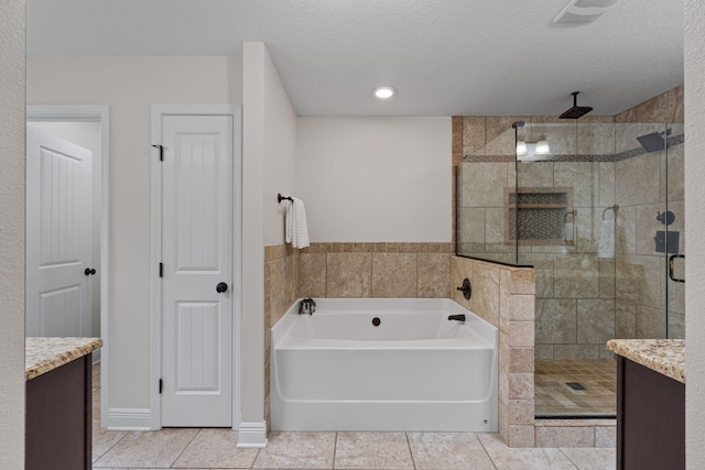 7478 Brevard St, Navarre, FL 32566 - full bathroom featuring a shower stall, a garden tub, tile patterned flooring, vanity, and a textured ceiling