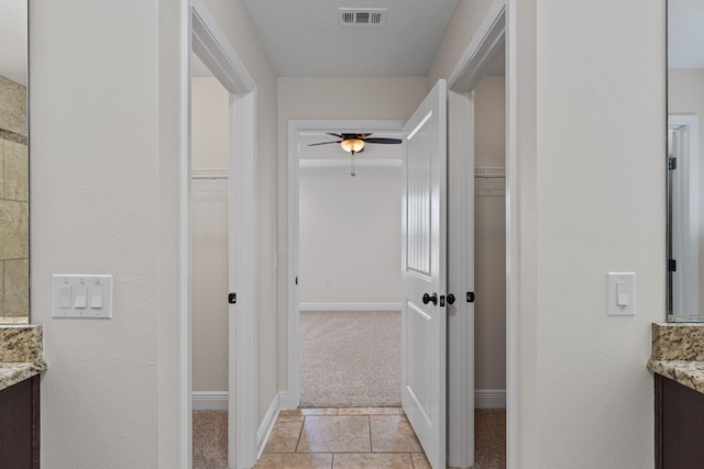 7478 Brevard St, Navarre, FL 32566 - hall featuring light colored carpet and light tile patterned floors