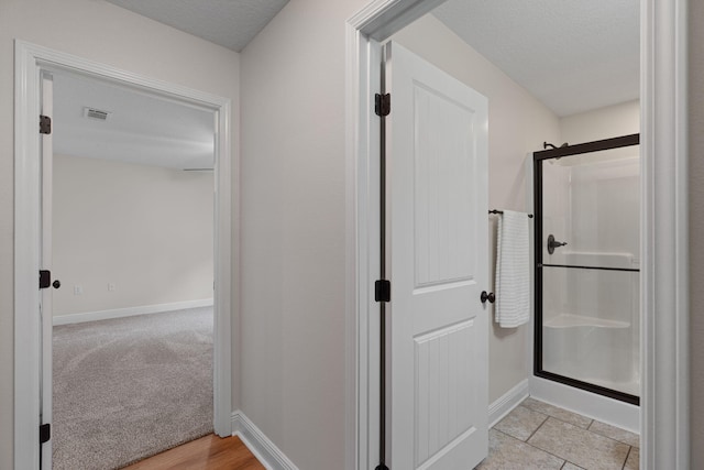 7478 Brevard St, Navarre, FL 32566 - full bath featuring a shower stall and a textured ceiling