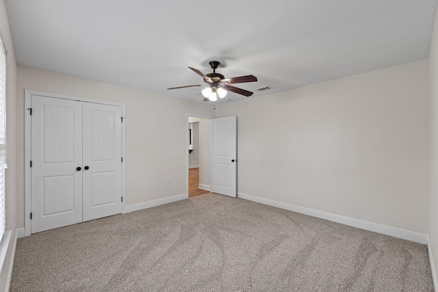 7478 Brevard St, Navarre, FL 32566 - unfurnished bedroom with carpet flooring, a closet, and ceiling fan