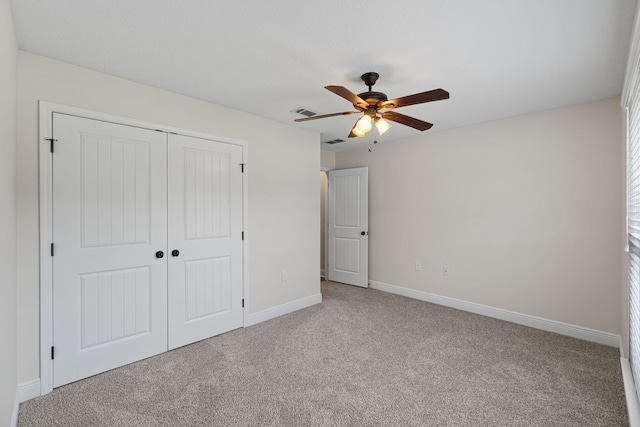 7478 Brevard St, Navarre, FL 32566 - unfurnished bedroom with carpet, a closet, and ceiling fan