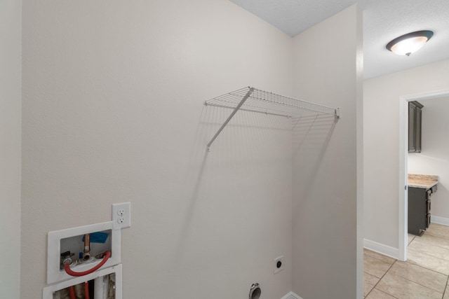 7478 Brevard St, Navarre, FL 32566 - washroom with hookup for an electric dryer, light tile patterned floors, and hookup for a washing machine