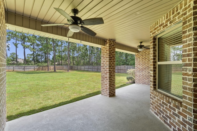 7478 Brevard St, Navarre, FL 32566 - fenced backyard with ceiling fan and a patio area