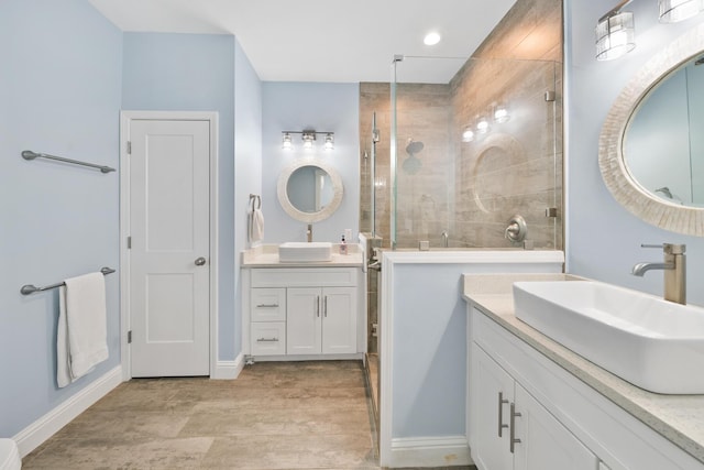 115 N Barcelona Ave, Santa Rosa Beach, FL 32459 - bathroom featuring tiled shower, two vanities, and wood finished floors